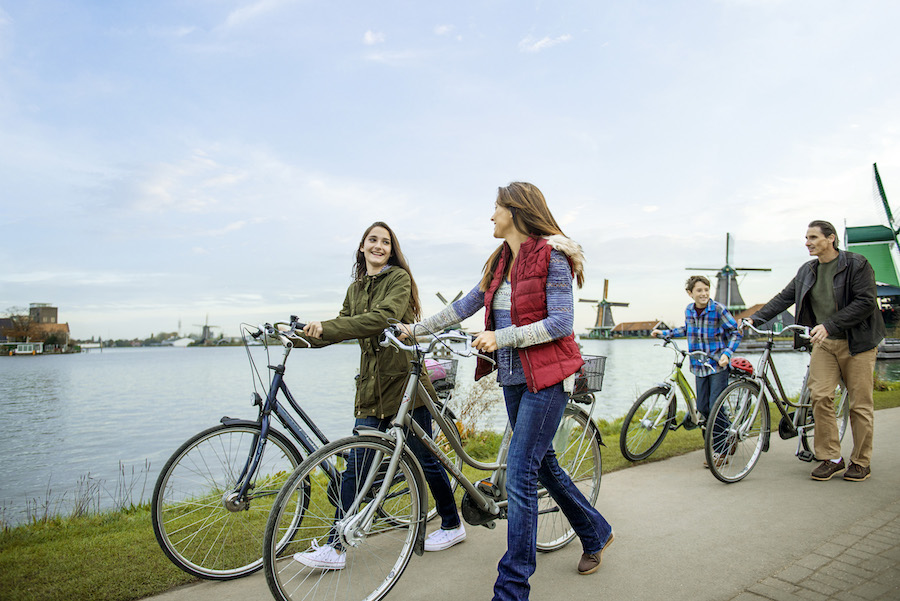 Family riding bike on Adventures by Disney vacation