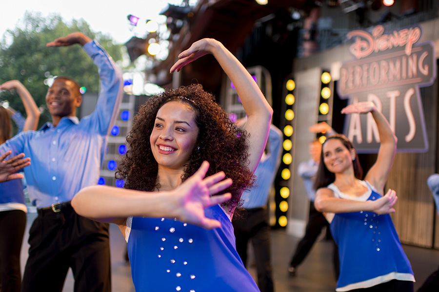 Student dance ensembles performing onstage