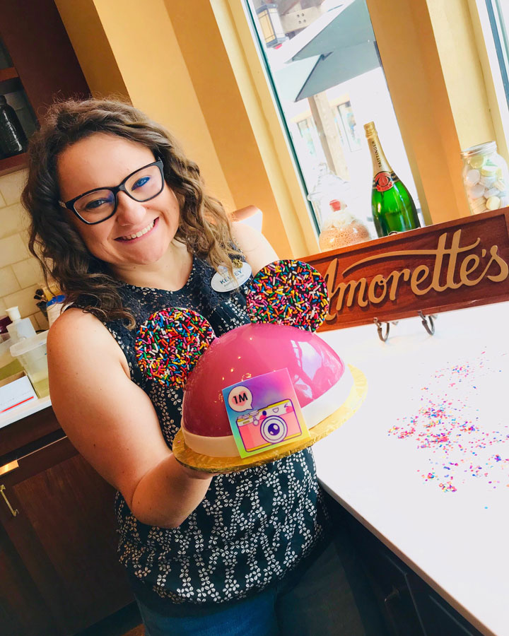 Diz Planet author Kelsey Noland at Amorette’s Patisserie with celebration cake 