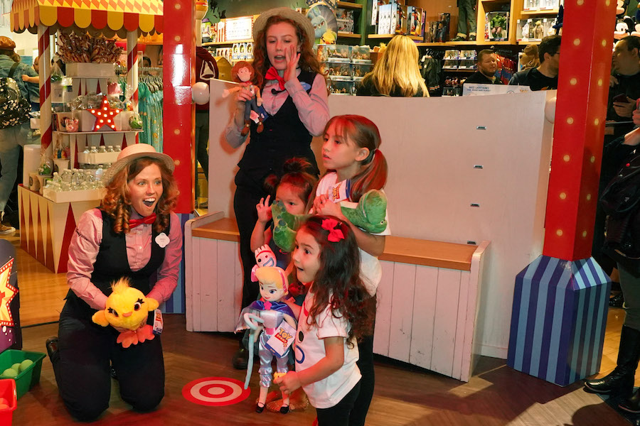 Cast member at a Disney Store locations playing a game with a guest