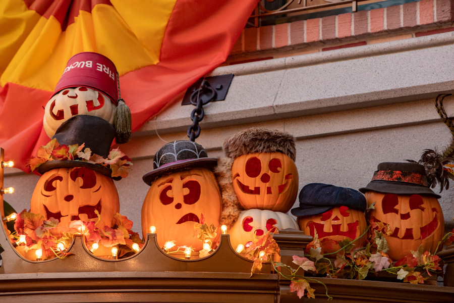 Carved pumpkins surrounding the marquee of the Mad Hatter on Main Street, U.S.A.