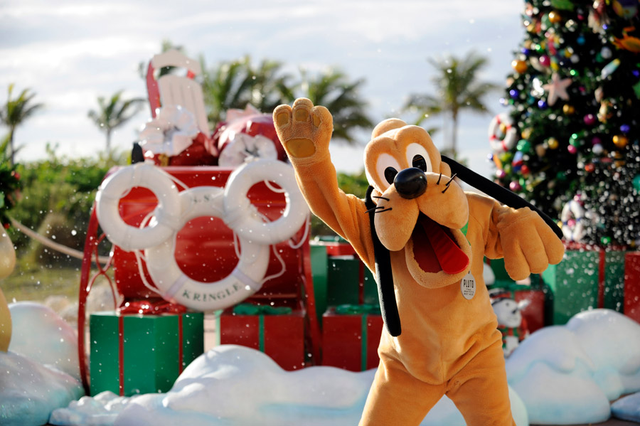 Pluto poses in front of holiday decor on Castaway Cay