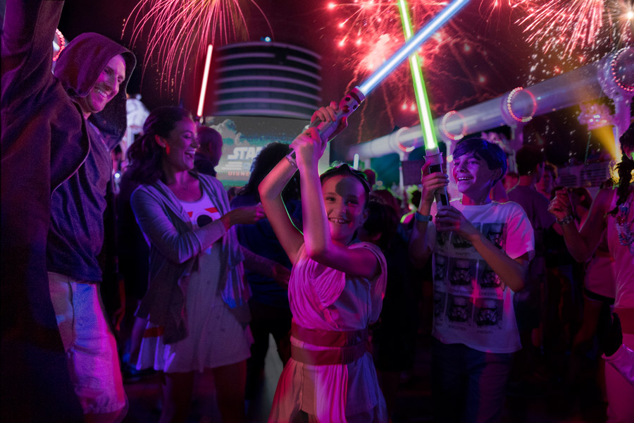 Little girl dresses as Rey and her family at the “Summon the Force” deck party during Star Wars Day at Sea