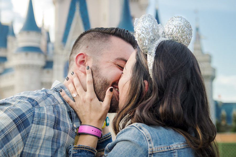 Couple getting engaged at Magic Kingdom Park