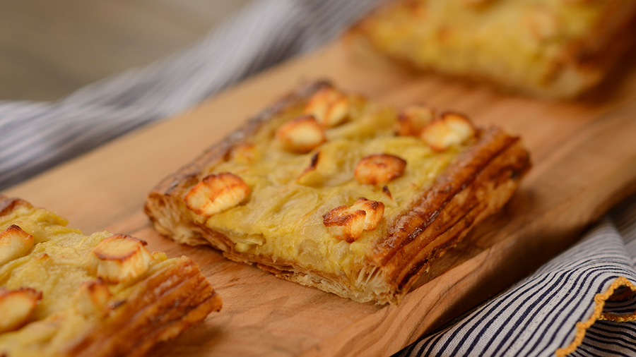 Offerings from France Marketplace for the 2020 Epcot Taste of International Food & Wine Festival - Tarte aux Oignons Caramelises Et Chévre: Goat Cheese Tart with Caramelized Onions on a Flaky Pastry Crust 
