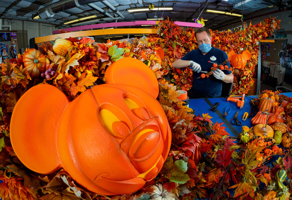 Cast member making fall decor