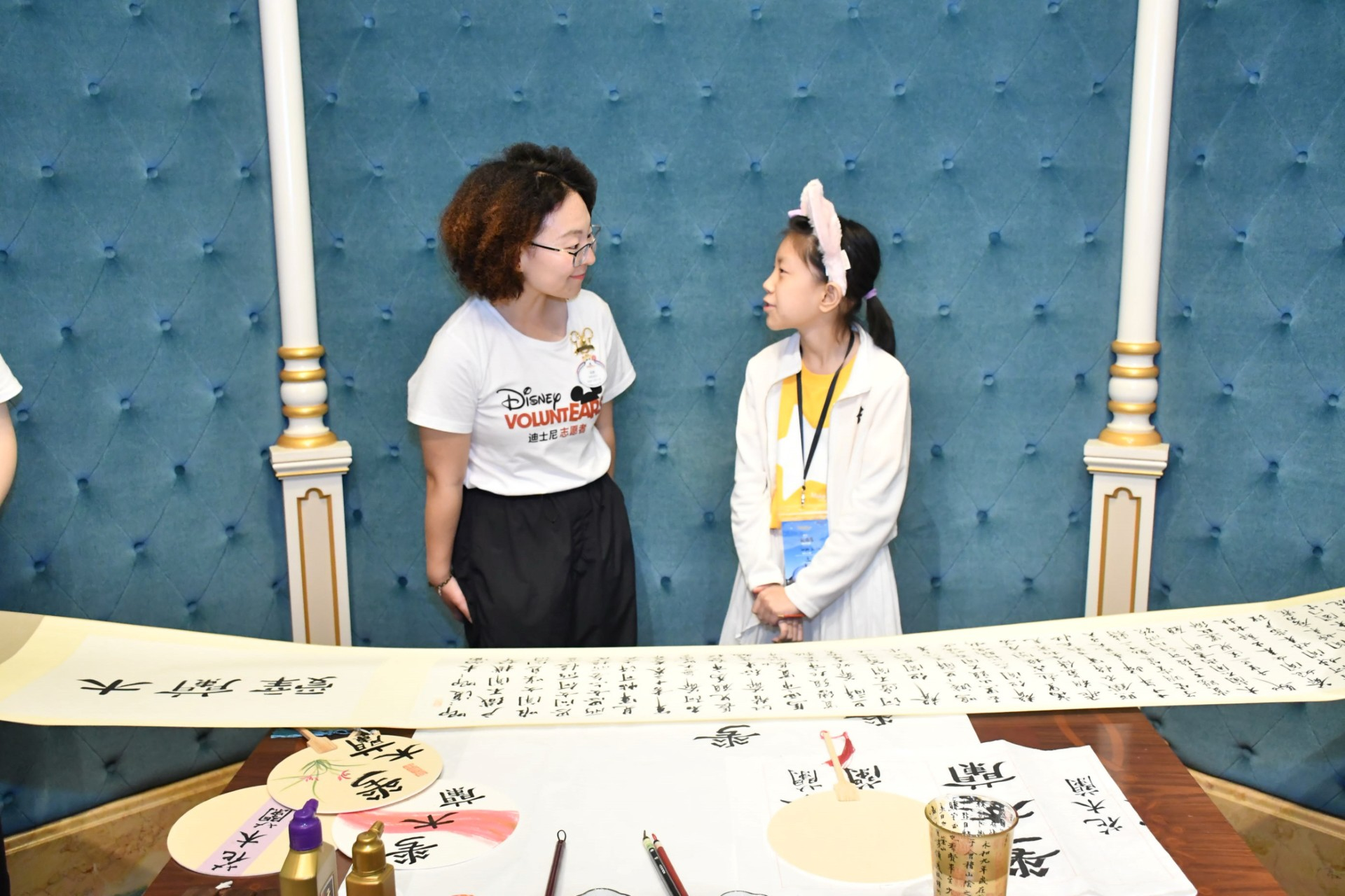 Xuanxuan learns calligraphy alongside VoluntEARS 