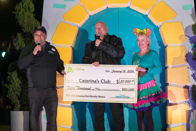 Chef Bruno accepts a donation from Disneyland Resort President Ken Potrock and Anaheim Mayor Ashleigh Aitken in honor of Caterina’s Club as the celebrated charity of the 2024 Disneyland Half Marathon Weekend.