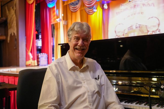 Randy smiles in front of his piano at Hoop-Dee-Doo Musical Revue