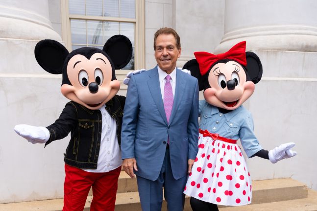 Nick Saban poses with Mickey Mouse and Minnie Mouse