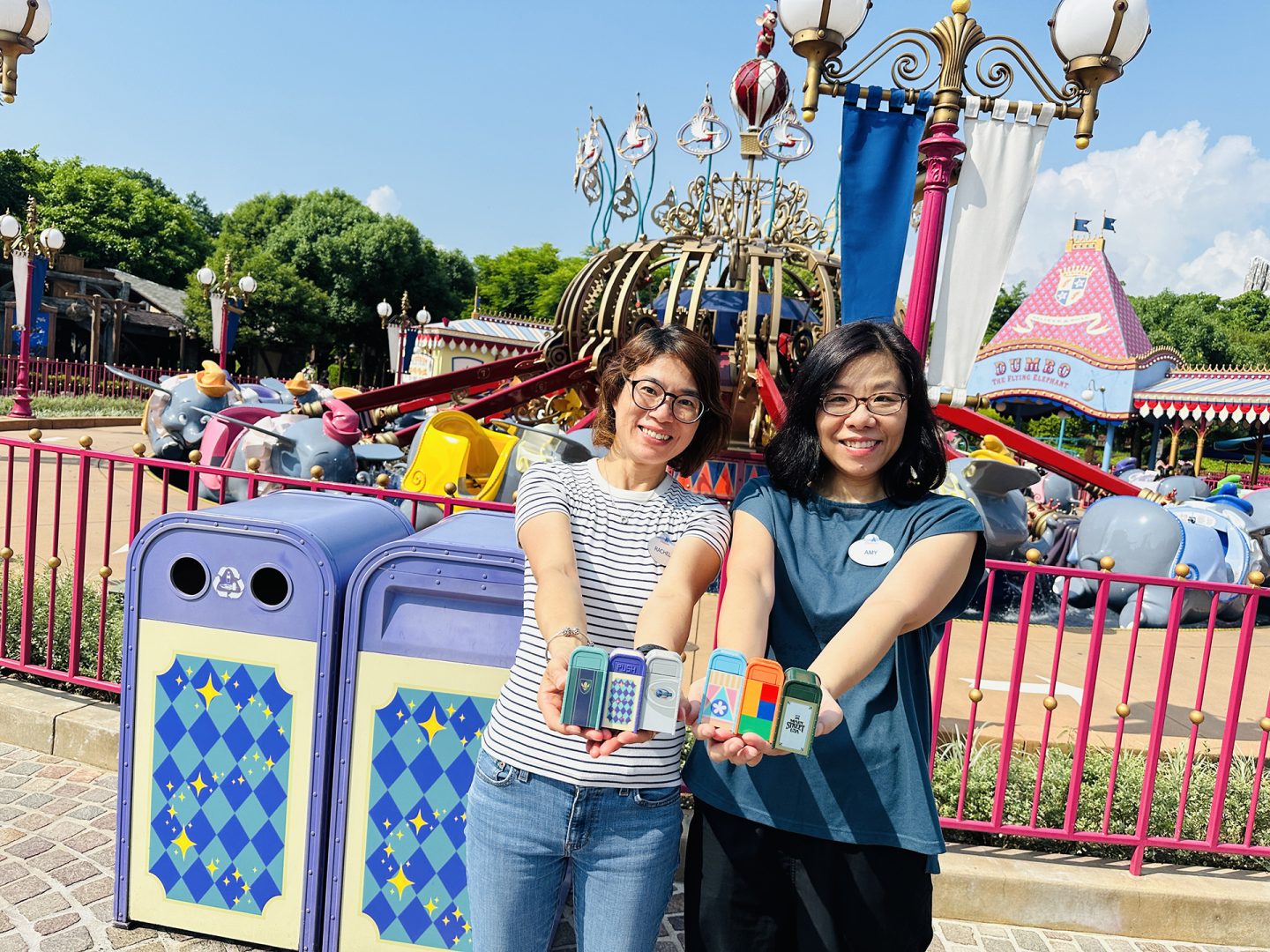 The creators of the trash cans pose with their miniature creations